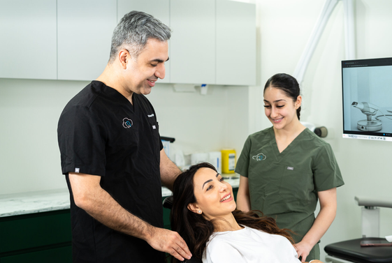 The Cloud Nine Dental team caring for a smiling patient